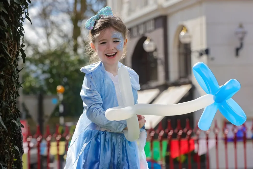 Wander Wild Festival Kids Zone little girl wearing fairy dress holding balloons