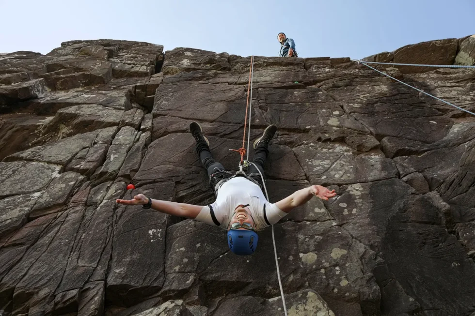 Wander Wild Festival guy abseiling upside down on rocks