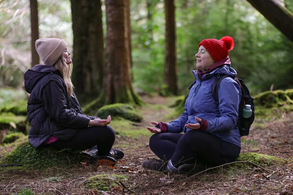 Wander Wild women practing Mindfulness in forest