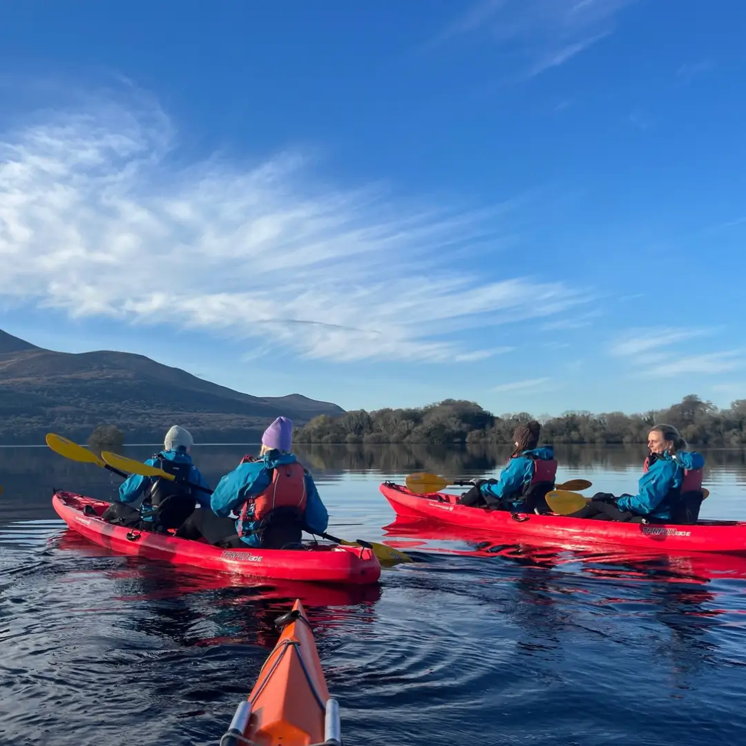 Two kayaks with people kayaking on the lakes