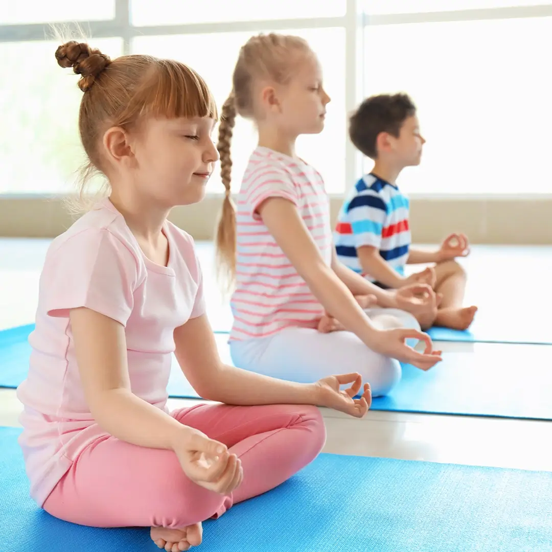 Little children practicing yoga indoors