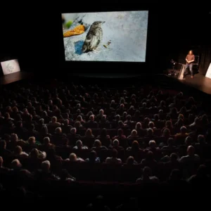 Séan Ronayne on the stage at a speaker event with an audience