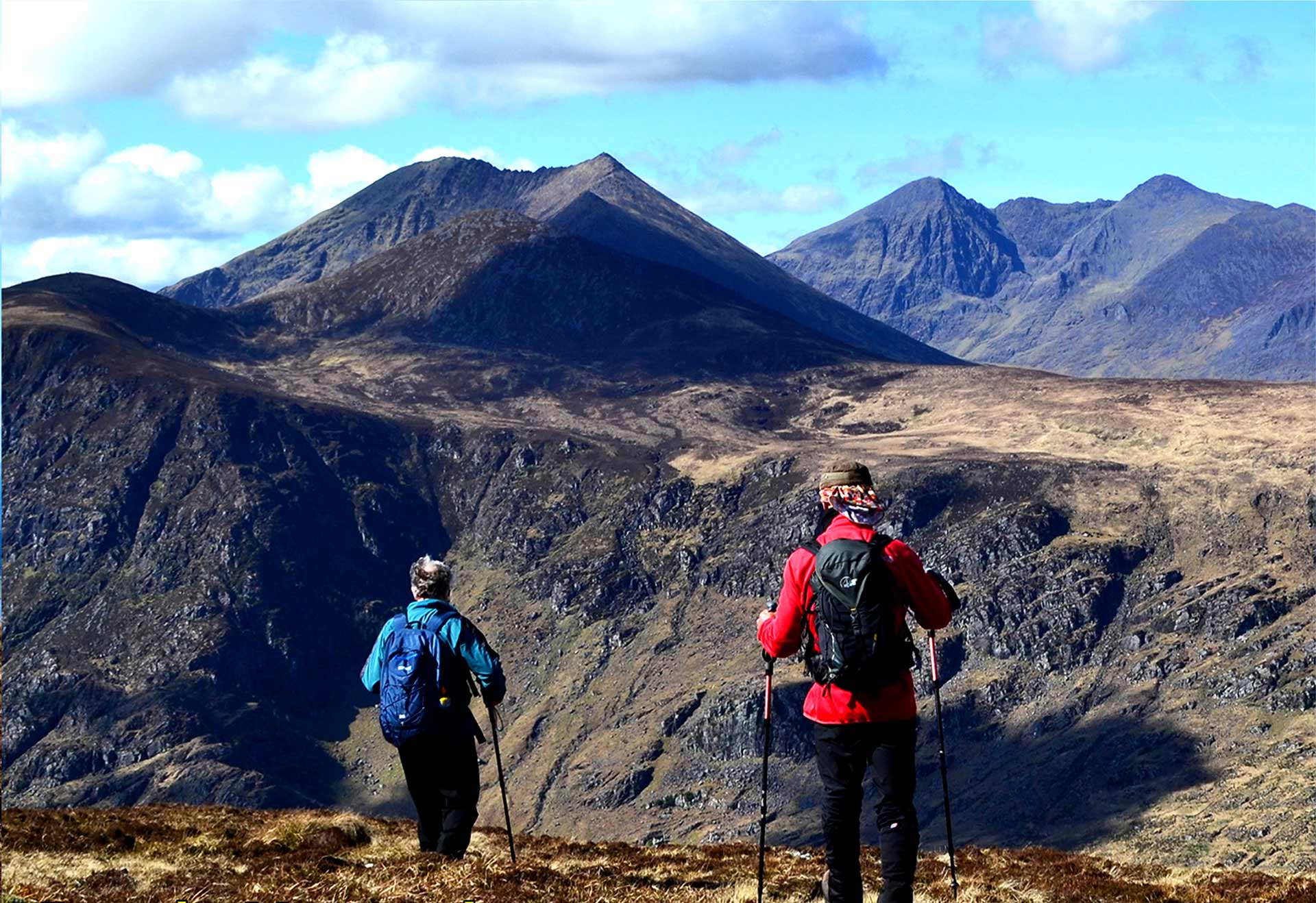Hikers at the top of a mountain with hiking poles
