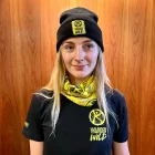 A lady wearing a black wander wild beanie