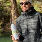 A man posing with a water bottle