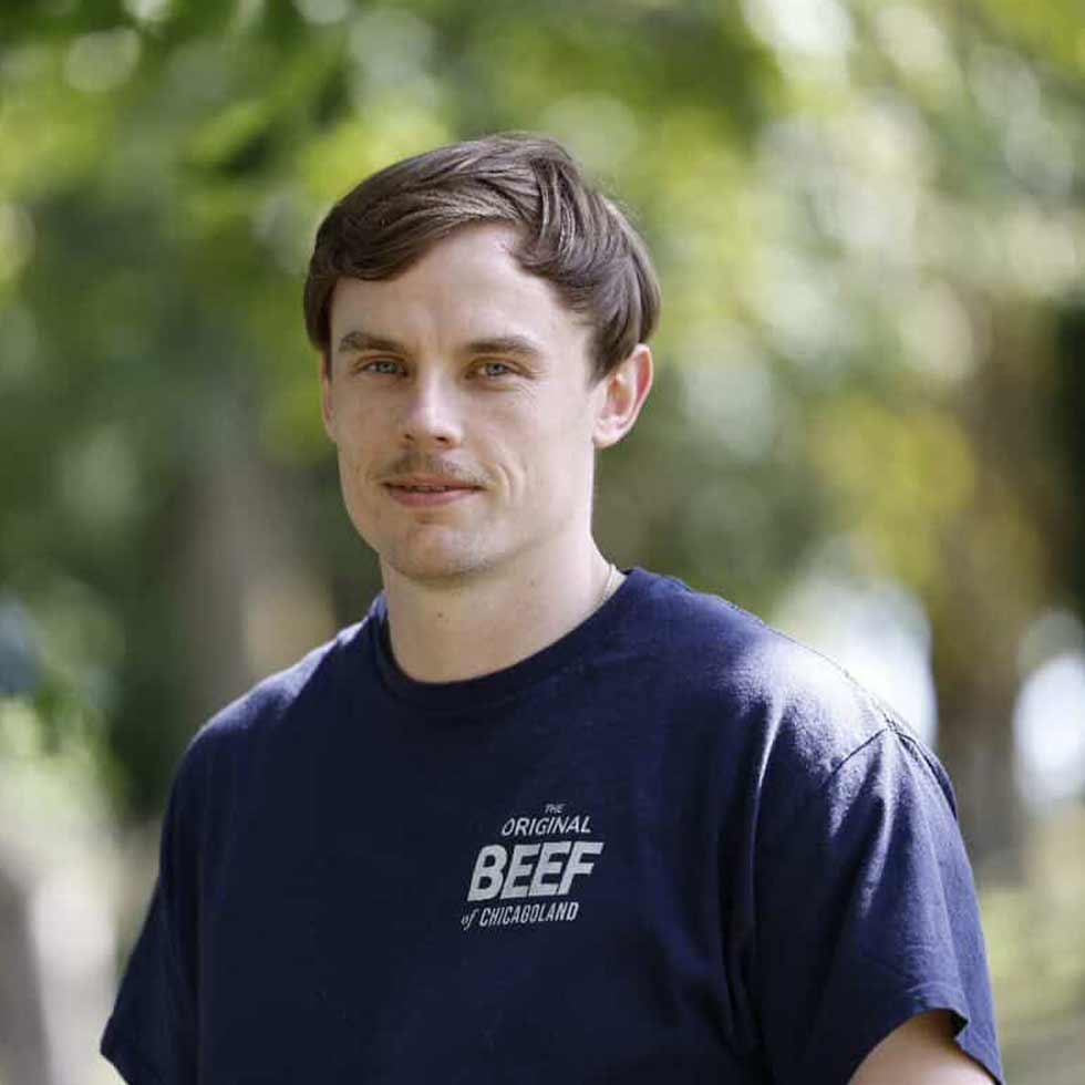 A man smiling and posing for a photo