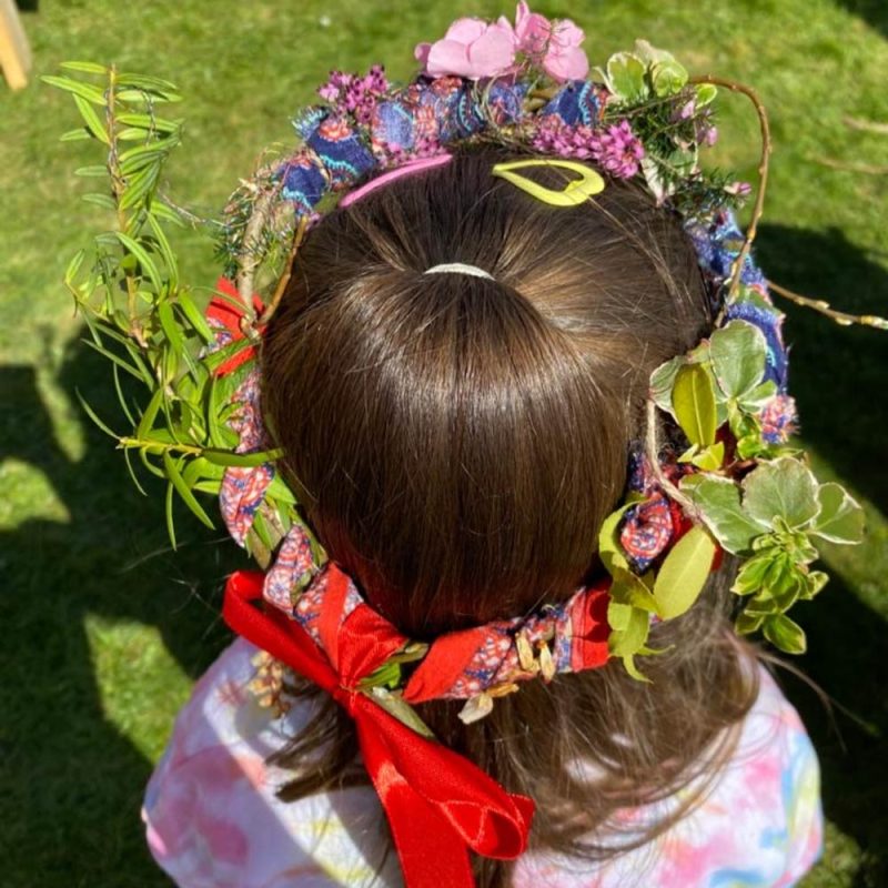 A girl wearing a crown of flowers