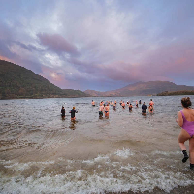 Swimmers running into the lakes of Killarney