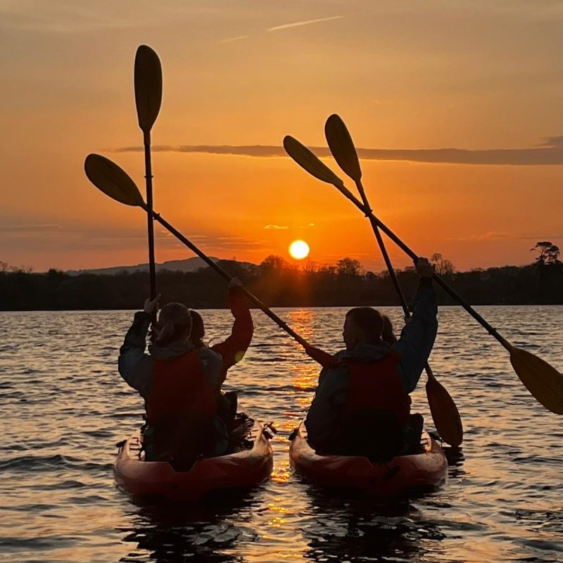 A group of kayakers celebrating