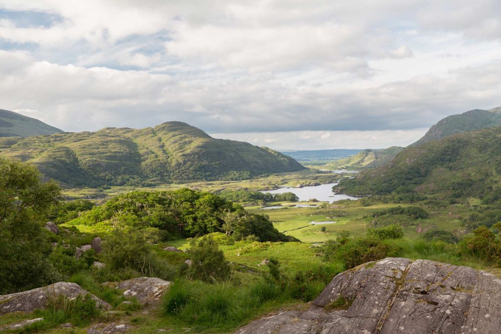 Golden sunlight cast over the rolling mountains and lakes of Killarney